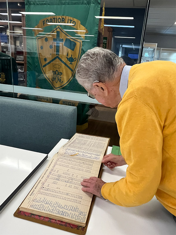 Richard Bailey looking through an archived sign in book